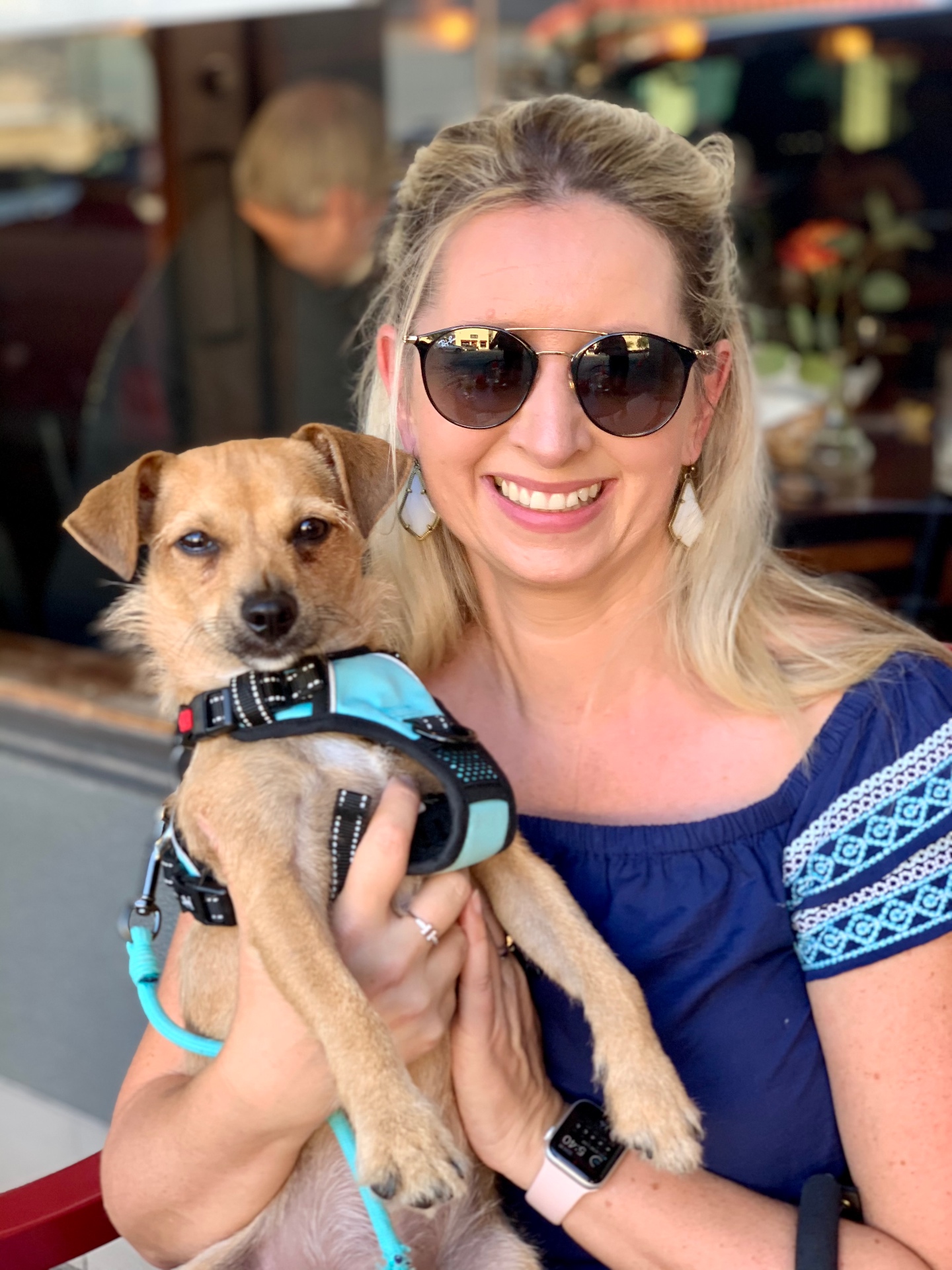 Tracy O'Meara holding Monty, her sandy-golden rescue terrier from Texas, at a café in Cork